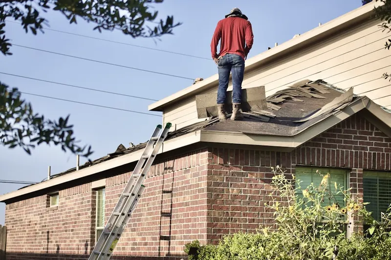 Professional roofer working on a residential roof in Kingsbury
